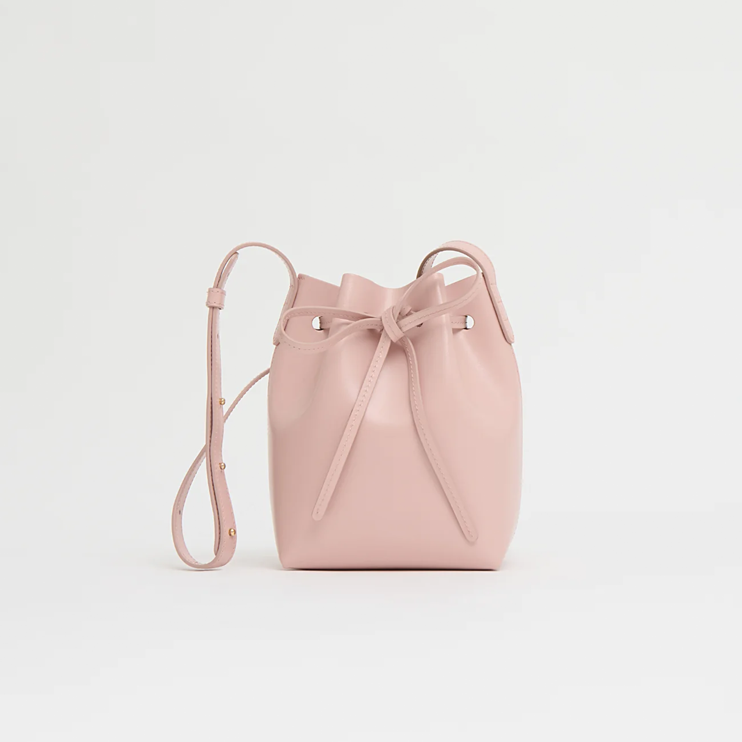 Delicate Blush Pink Petite Tapered Bucket Silhouette Bag With Neat Knotted Drawstring Closure And Slender Matching Carry Strap